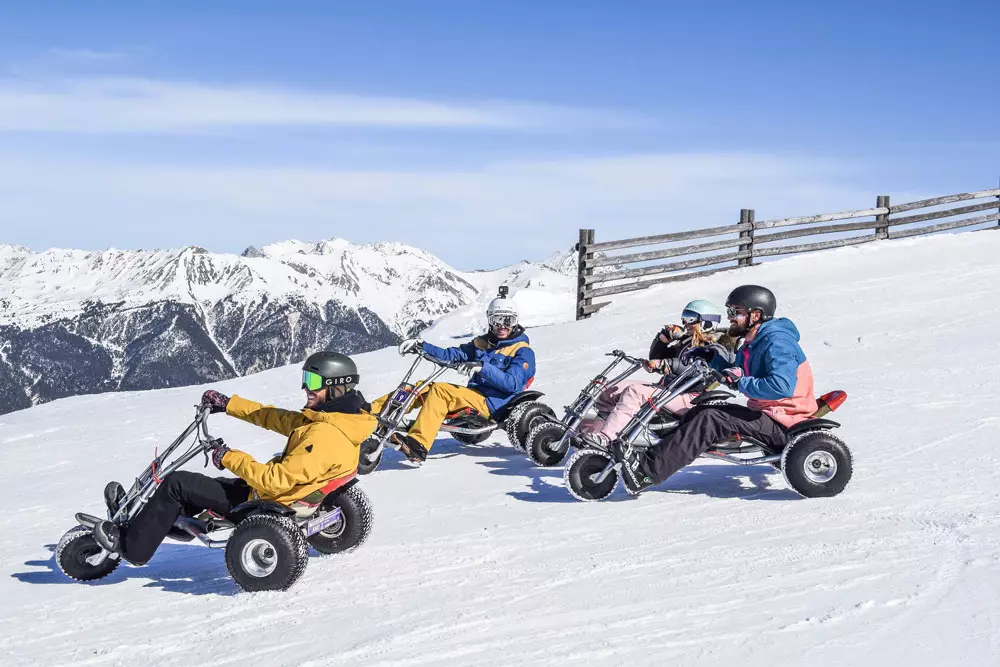 group of people driving a kart on serre che mountain slope
